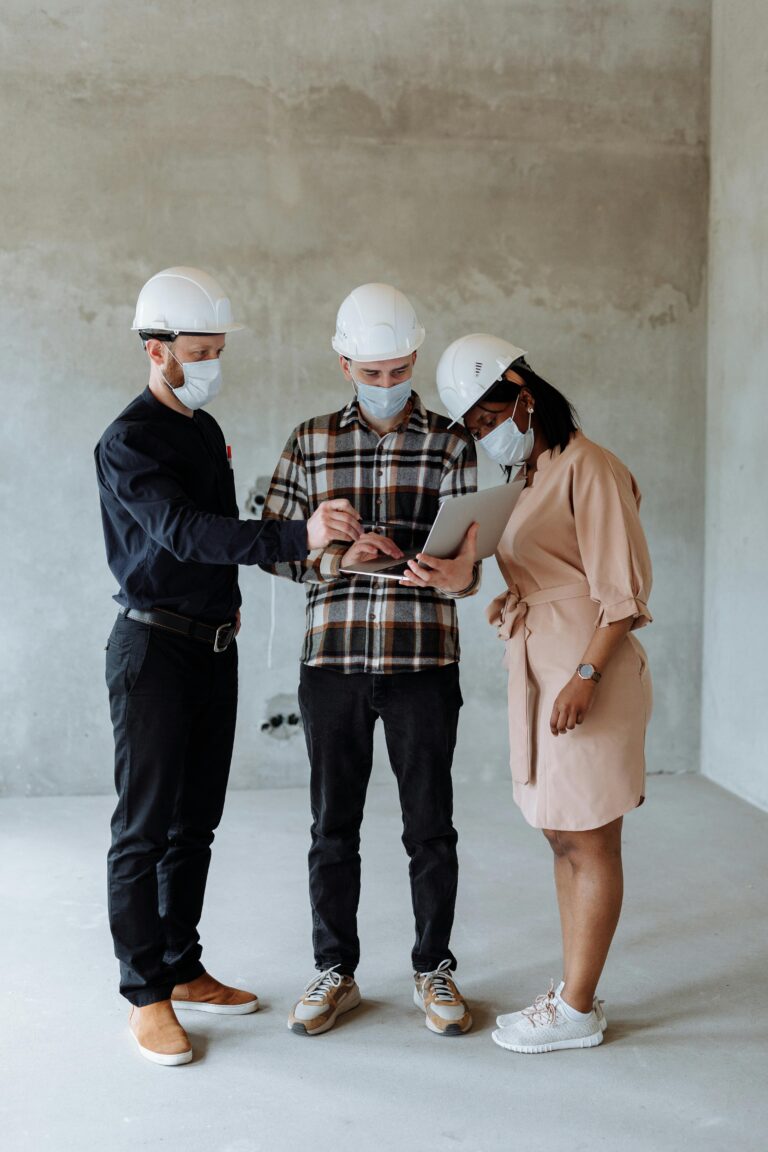 Three workers discussing the renovation strategy