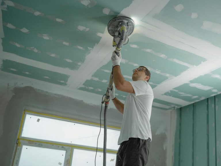 Worker painting the ceiling